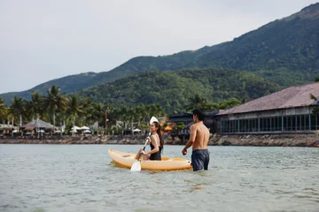 Foto op Canvas Kayaking Harmony: A Joyful Asian Couple Paddling in the Serene Tropical Waters © SHOTPRIME STUDIO
