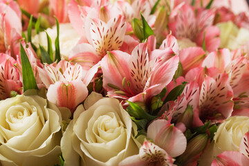 A large bunch of pink alstroemerias and white roses close up. Selective focus. The farmer's market.