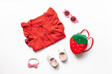 Set of baby girl dress and accessories, top view. Kids wear flat lay