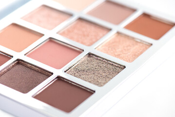 Eye shadow palette in nude beige shades, closeup.