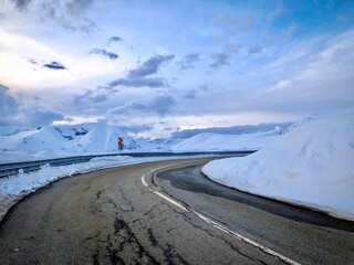 Empty road winding through the mountains in winter