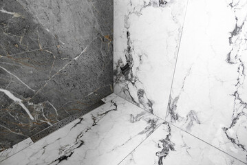 Stainless linear shower drain system in shower room.