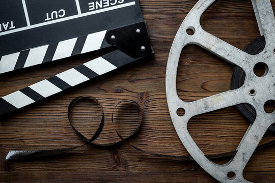 Cinema and filmmaker concept with film reels and clapperboard