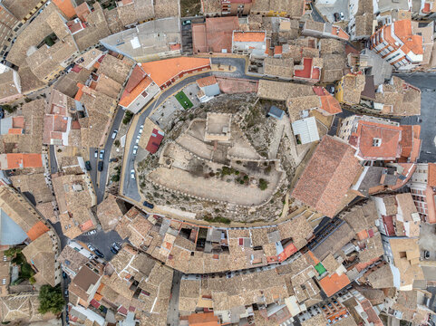 Aerial ground plan view of Banyeres de Mariola in Valencia province, Moorish hilltop castle surrounded by mountains, almond and olive trees. The castle is irregularly shaped, two enclosures 