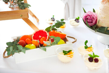 Candy bar with cake, tiramisu, panna cotta and citrus. Birthday party