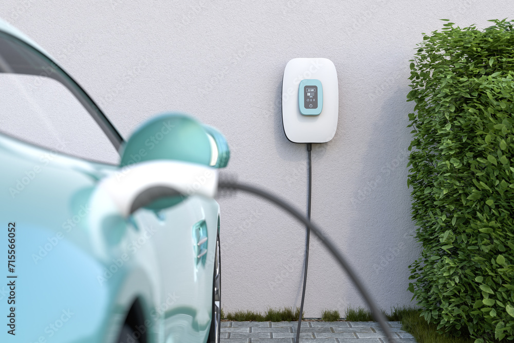 Wall mural charging an electric vehicle at home with a home charging station (wallbox). focus on the wallbox di