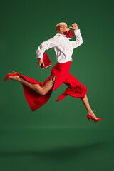 Hurry up. Dynamic side view portrait of business lady in trendy office wear running to work in...