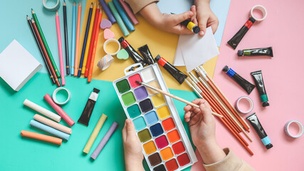 Back to school. Panoramic education banner. Top view, flat lay. Colorful supplies on table, colored paper. Children's creativity concept. Preschool study, development. Accessories for the schoolroom