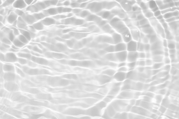 White water with ripples on the surface. Defocus blurred transparent white colored clear calm water surface texture with splashes and bubbles. Water waves with shining pattern texture background.