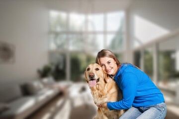 Happy young woman hugging her dog at cozy home.