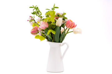 Elegant mixed pastel colored spring bouquet in white vase on white background. Spring flowers. Tulips bouquet.