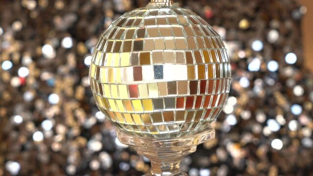 silver ball with mirrors rotates