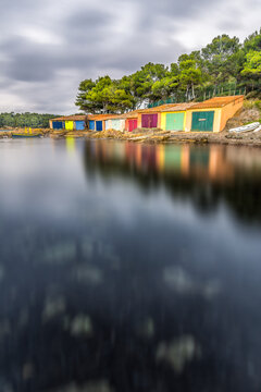 Scenic view of colored boat shelters in south of France on rainy cast during winter near Saint Tropez