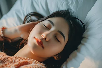 Poster sleeping young asian woman lies in bed with eyes closed © senyumanmu