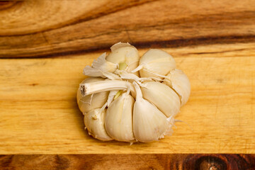 garlic on a wooden chopper in the kitchen ready to be added to food.