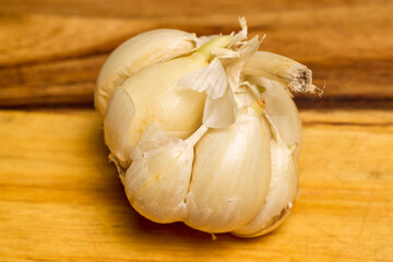 garlic on a wooden chopper in the kitchen ready to be added to food.