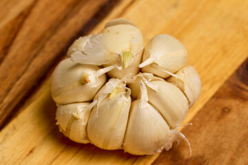 garlic on a wooden chopper in the kitchen ready to be added to food.