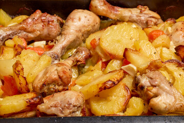 Chicken thighs with potatoes ready to eat.