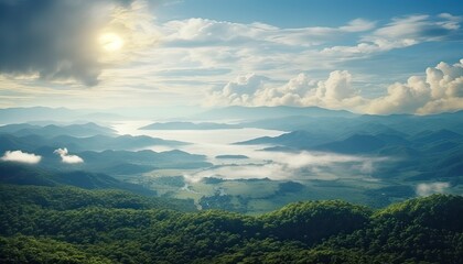 Fototapeta premium View of the sea of clouds from the top of the mountain peak. Tropical rainforest with vibrant morning reflection of the sunrise.