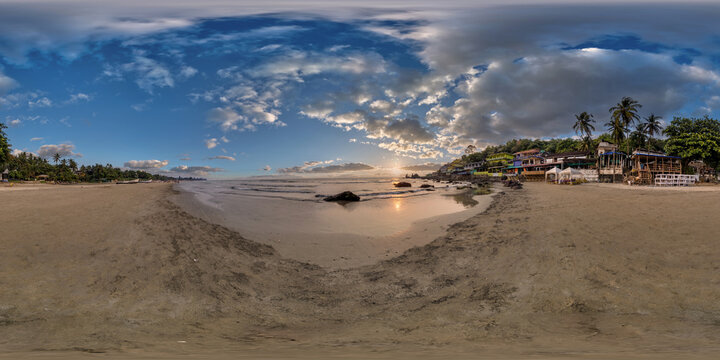 360 hdri panorama with coconut trees on ocean coast on beach at sunset in equirectangular spherical seamless projection