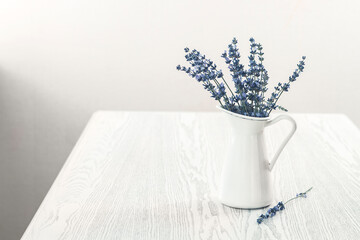 Bunch of Lavender in white vase on the wooden table © Dasha Petrenko
