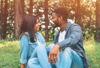 Fototapeta premium A handsome man and beautiful woman hugging each other and spending time in the park Toned inage Time together