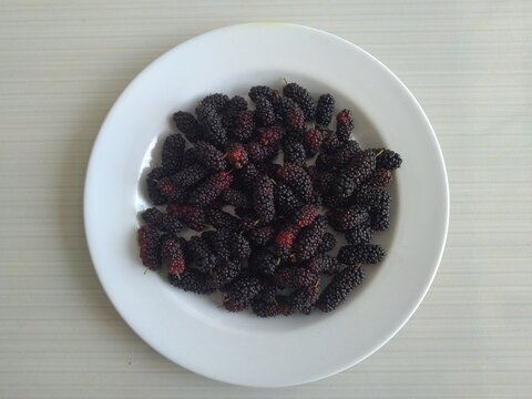 mulberries in a white plate