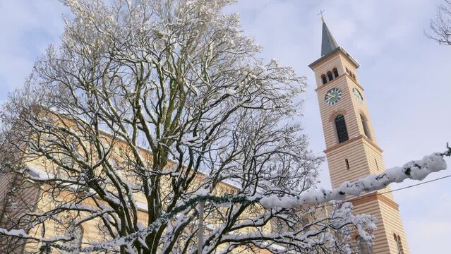 Bavarian church next to tree in winter