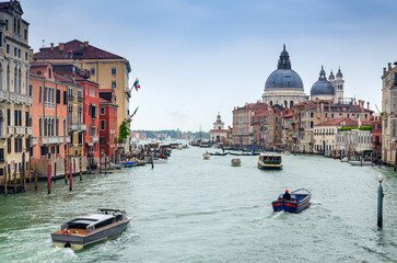 Grand canal in Venice, Italy, with divine Santa Maria della Salute church domintaing in the cityscape