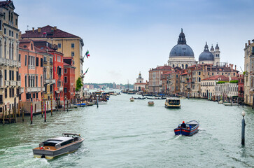 Grand canal in Venice, Italy, with divine Santa Maria della Salute church domintaing in the...
