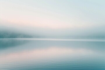 Obraz premium Foggy morning on the lake. Beautiful natural background. Long exposure. A minimalist photograph capturing the delicate dance of morning mist over a tranquil lake.