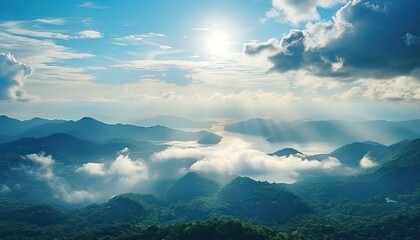 View of the sea of clouds from the top of the mountain peak. Tropical rainforest with vibrant morning reflection of the sunrise.