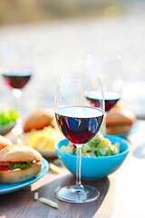 Picnic table with red wine glasses