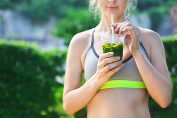 Fitness athlete woman resting drinking organic drink