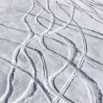 Snowy off-piste ski slope with trace from skis