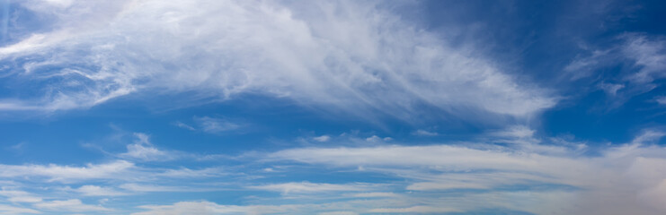 Blue sky with light airy white cirrus clouds for background