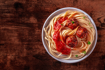 Meatballs. Beef meat balls, overhead flat lay shot with spaghetti pasta, parsley, and tomato sauce,...