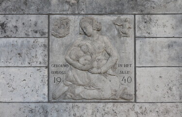 Sculpted Tablet Depicting a Woman Breastfeeding on a Building Facade in Amsterdam, Netherlands
