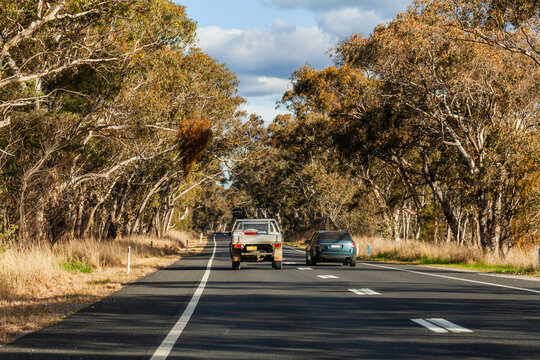 Vehicle overtaking ute on dotted lines on rural highway road
