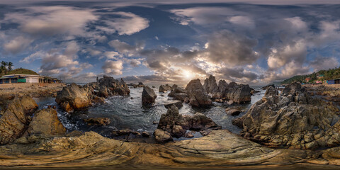 Fototapeta na wymiar full hdri 360 panorama view on ocean on shore with rocks at sunset with beautiful clouds in sky in equirectangular projection with zenith and nadir. VR AR content