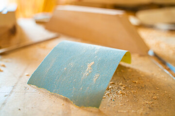A piece of blue sandpaper on a table in a carpentry workshop