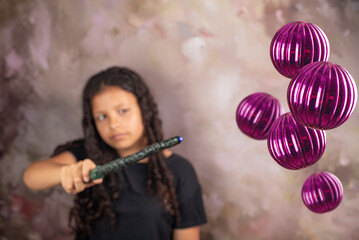 Teenage Brazilian woman with magic wand, abstract background, selective focus.