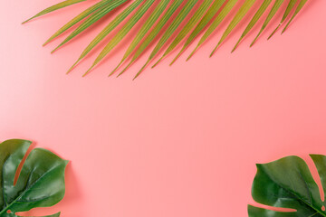 Palm tree leaves on pink background. Creative minimal summer concept.