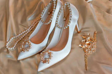 Weddings women white shoes with a heels with a flowers and pearls. Concept of Wedding, accessorize