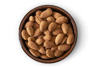 Almonds in a baked clay plate seen from above isolated on empty background
