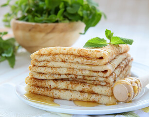 thin French crepe pancakes with fresh berries and honey