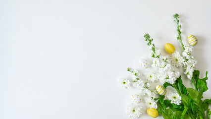 Creative  easter template  with easter eggs and white flowers on a white background.