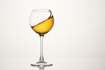 White wine diagonal wave, curl is in stemmed glass.
