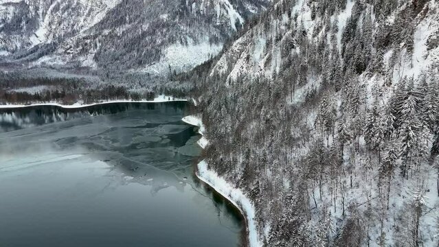 Drohnenflug &uuml;ber dem See in den Bergen in sch&ouml;ner Landschaft im Winter im Salzkammergut