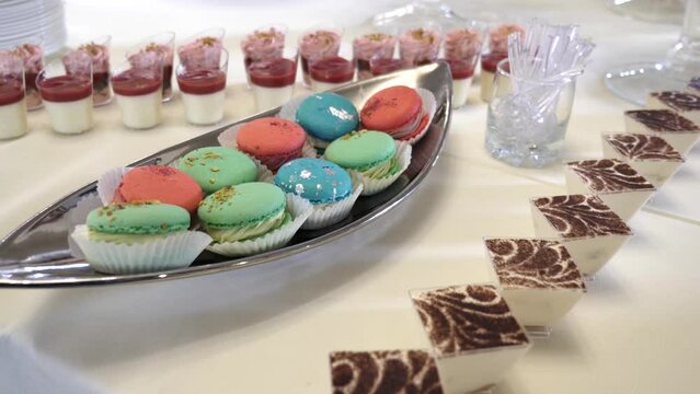 Festive buffet with pastries, mousses, cakes and donuts. Slow motion.